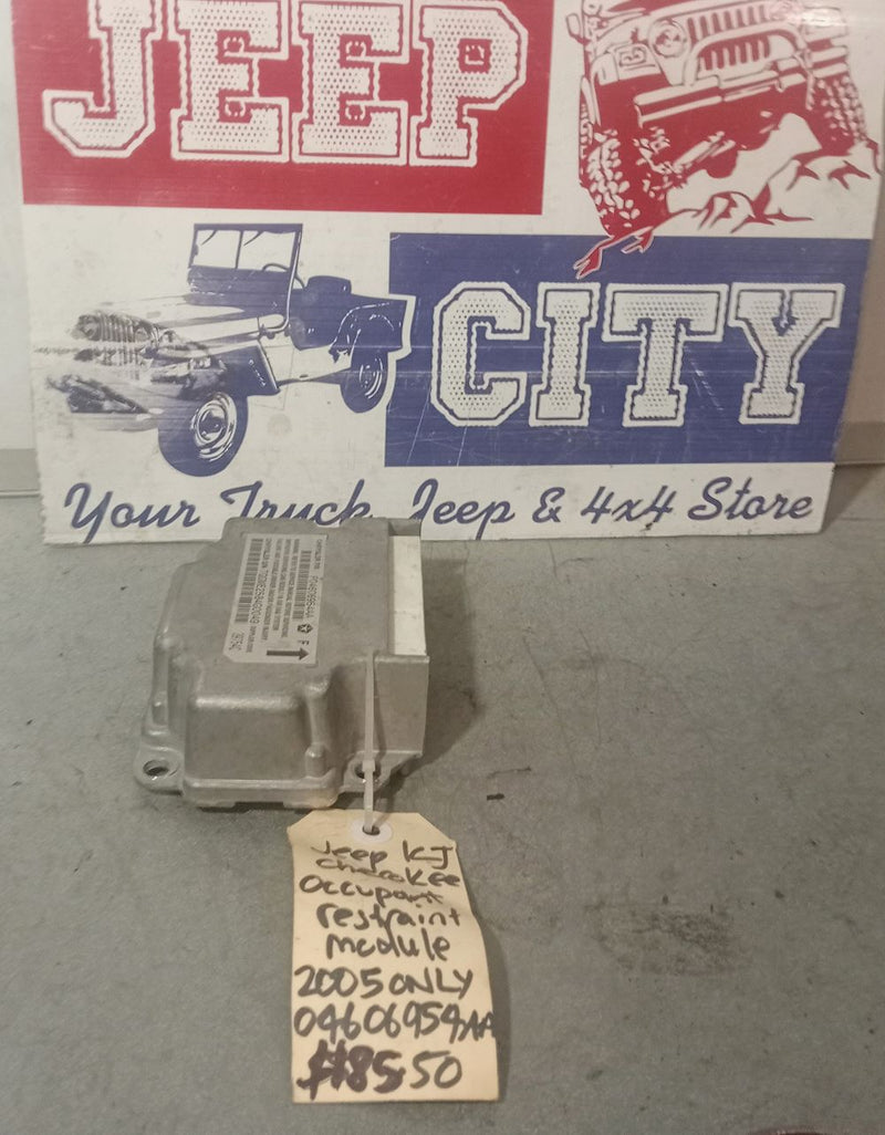 Airbag Occupant Restraint Module with a tag showing part number 040606954AA displayed in front of a sign that reads 'Jeep City'.