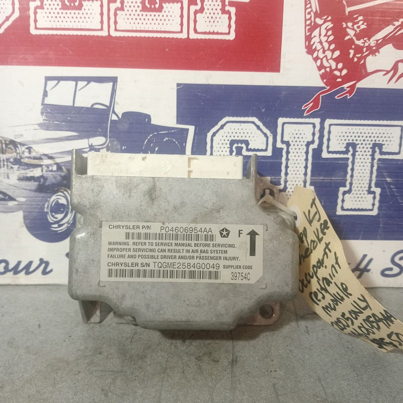The part number 04606954AA corresponds to a genuine Mopar SRS Airbag Control Module designed for the Jeep Cherokee / Liberty (KJ series) built between 2002 and 2007.
