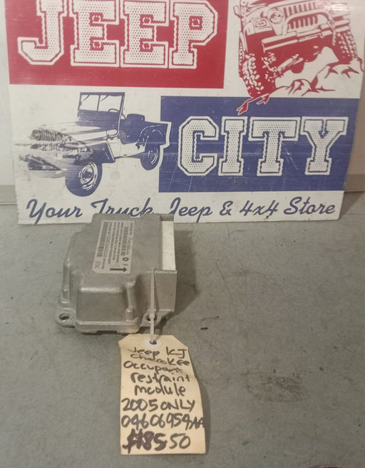 Airbag Occupant Restraint Module with a tag showing part number 040606954AA displayed in front of a sign that reads 'Jeep City'.