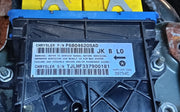 A close-up of a black plastic automotive part with a blue top section and a white printed label. The label reads Chrysler with part number P68046205AD and other part details.