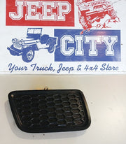 Mopar Part 68143099AC: Jeep Lower Grille BezelPart number 68143099AC is a genuine Mopar Lower Grille Bezel (Driver Side / Left). It functions as the front lower bumper tow hook plug or insert panel for the 2014–2016 Jeep Grand Cherokee