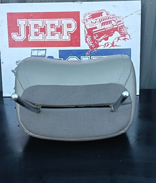 A Jeep passenger seat with a light Light grey leatherette outer shell and a gray fabric insert, displayed on a dark surface with a Jeep City-branded sign in the background.