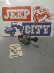 A Jeep TJ XJ headlight switch with knob, positioned in front of a 'Jeep City' themed sign.