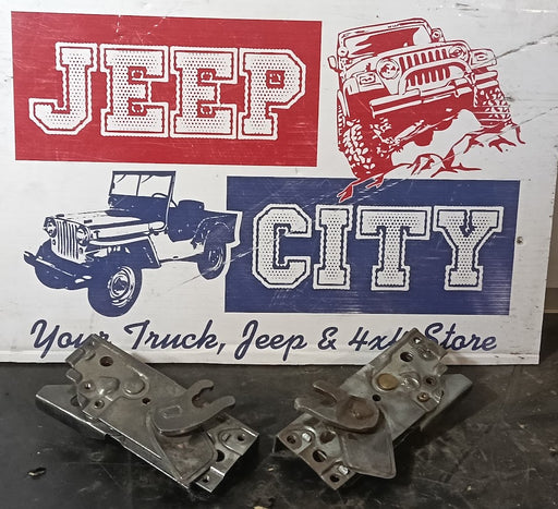 Two used metal Willys Pickup Door Lock mechanism in good clean working condition sign that reads 'JEEP CITY' with illustrations of jeeps.