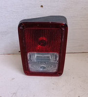 Red and clear rectangular automotive tail light on a white background
