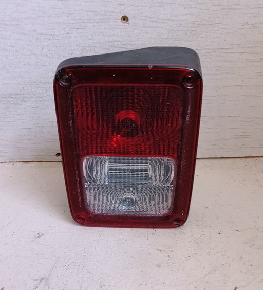 Red and clear rectangular automotive tail light on a white background